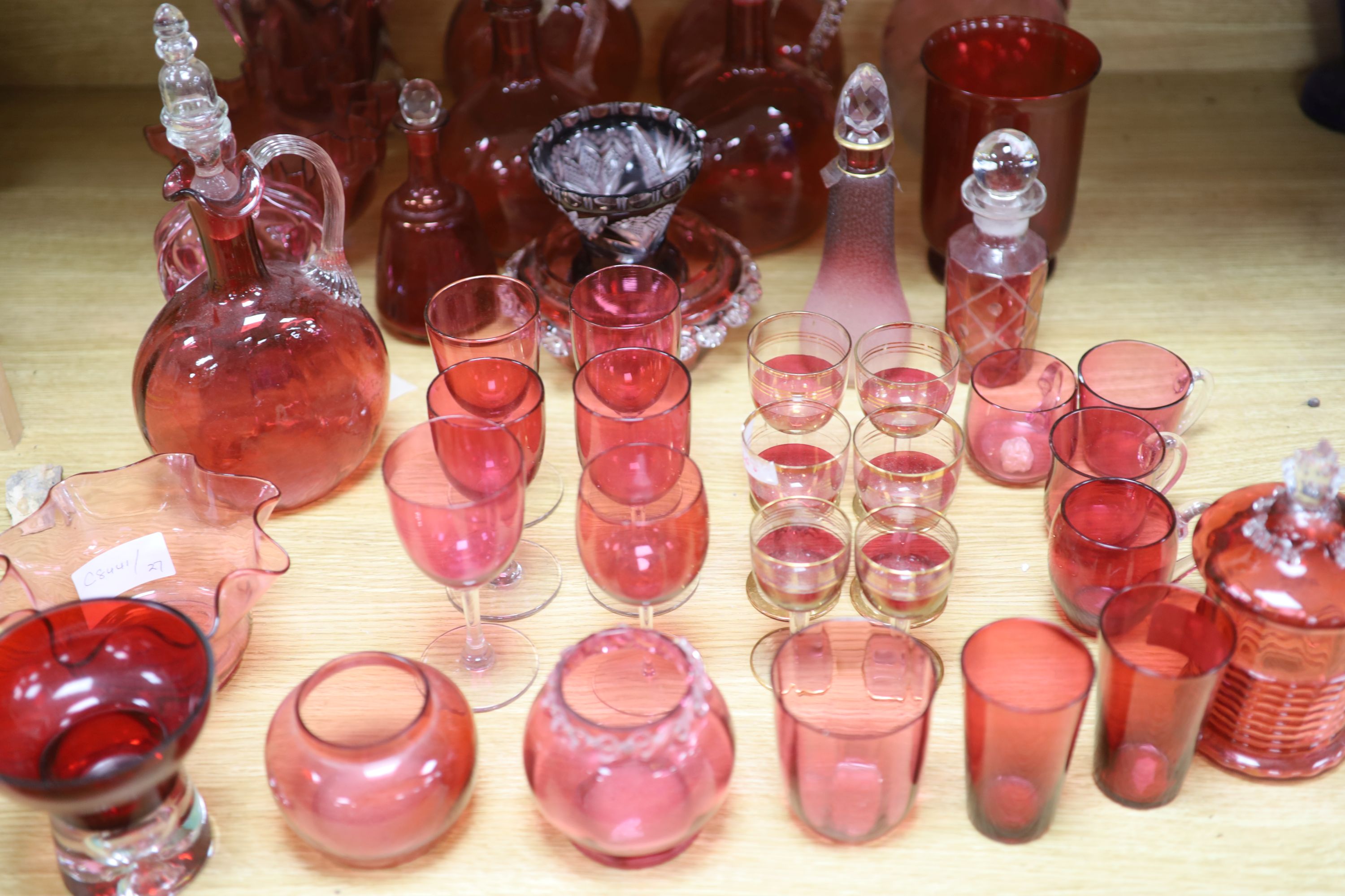 A large collection of cranberry glass